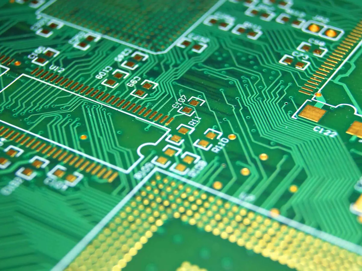 Close-up of routed trace pairs and fine-pitch pads on a multilayer PCB, the kind of high-speed routing Isola FR408HR supports